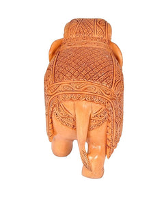 Elephant wooden statue, rear view; carved back pattern and trunk-down stance.