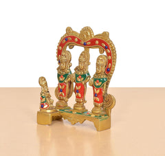 Side view of brass Ram Darbar idol with arched backdrop and three painted figures