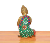 Back view of brass seated Buddha idol with multicolor patterned robe