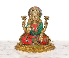 Brass Lakshmi idol on lotus base, teal-and-red attire with gold and gemstone-like trim