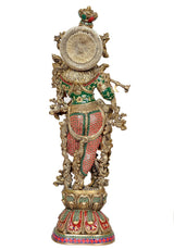 Brass Krishna statue, back view with circular halo disc and patterned garments