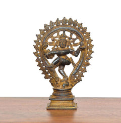 Copper Natraja dancing Shiva idol front view, detailed face and arched halo