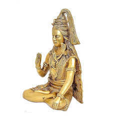 Brass Shiva statue side view, long hair and raised hand holding trident