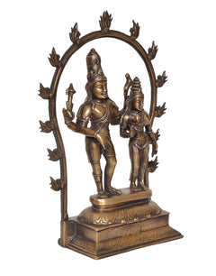 Brass Shiva and Parvati standing on decorated base under arched frame