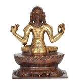 Brass goddess idol from behind view, seated on tiered lotus base