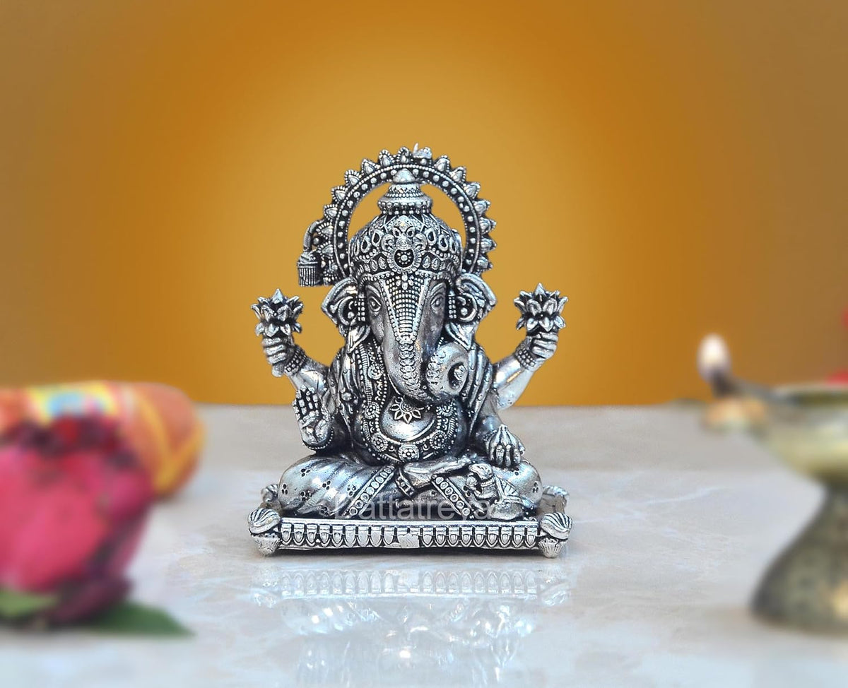 Brass Lord Ganesha seated idol with ornate crown, 3-inch height.