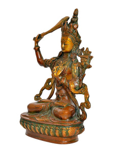 Brass Tara Devi statue, side view showing seated posture and green-gold detailing
