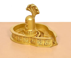 Side view of brass Shiva Ling murti on engraved round tray with raised ling