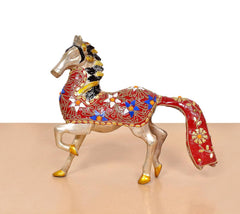 Brass horse statue running with red cloth saddle, gold trim and blue accents