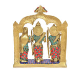 Brass Ram Darbar statue idol back view, golden figures under arched backdrop, jeweled accents