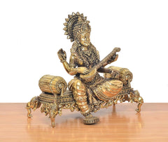 Saraswati brass idol seated with veena, crown and beaded jewelry, throne foot ornaments