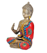 Brass meditating Buddha statue in side view, mosaic robe with raised hand