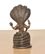 Back view of seated Vishnu resin statue on Sheshnag, textured serpent hood
