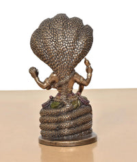 Back view of seated Vishnu resin statue on Sheshnag, textured serpent hood