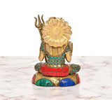 Back view of brass Shiva statue, seated with trident and ornate gemstone inlay
