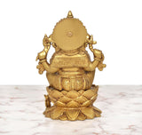 Back view of golden brass Ganesha seated on lotus with detailed carvings