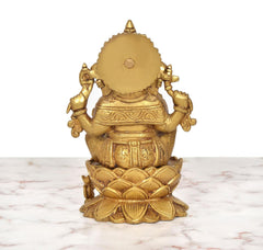 Back view of golden brass Ganesha seated on lotus with detailed carvings