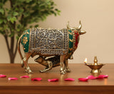 Side view brass cow ornament with calf, green and red detailing, for dashboard