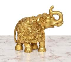 Brass elephant figurine close-up side view of ornate belly panel and trunk loop
