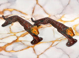 Jaguar-shaped brass door handle pair with cat head and extended tail, side view