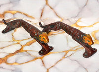 Jaguar-shaped brass door handle pair with cat head and extended tail, side view