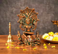 Brass Dakshinamurti Shiva statue with green detailing and orange seated figure on base