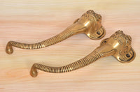 Brass Ganesha face door handle pair, gold tone, curved levers with round end knobs