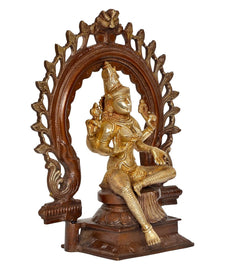Brass Lakshmi idol statue with raised blessing hands, seated under ornate arch