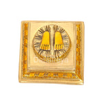 Close-up of brass Lakshmi charan paduka with two-toe lotus footprint