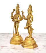 Brass Shiva and Parvati statues shown from the side, golden sculpted details