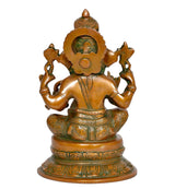 Brass Ganesh statue from behind, decorative halo and patterned lotus base