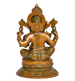 Brass Ganesh statue from behind, decorative halo and patterned lotus base