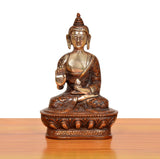 Brass Buddha idol seated front view, Abhaya mudra, ornate patterned base