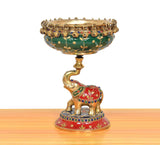 Brass elephant urli idol with painted cloth and jeweled rim, flower bowl on top