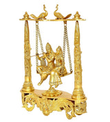 Brass Radha-Krishna idol swing, side view with carved platform and ornate support columns