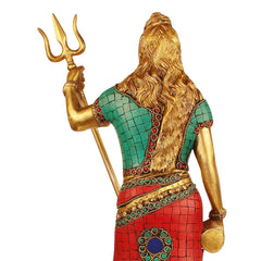 Brass Bholenath idol back view close-up, long hair, trident held up, green and red