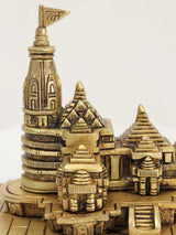 Brass mandir detail, ornate tower and small shrine figures on carved base