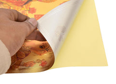 Gold-foil plated wall poster corner with deity artwork, shown being lifted