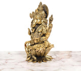 Lord Ganesha idol side view, detailed face, crown, and gold-toned ornaments