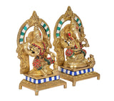 Brass Lakshmi-Ganesh statue pair, arched halos and jeweled red-and-green accents