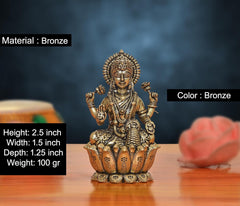 Bronze Lakshmi idol with lotus base; 2.5 in height, detailed 4-armed pose