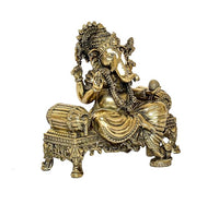 Brass Ganesha seated on detailed base, side view, 4 inch statue
