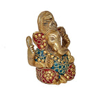Brass Ganesha statue, 3/4 back view with blue belt and red beadwork