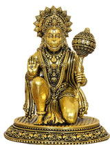 Golden Hanuman JI brass statue close-up, jeweled crown and raised hand mace