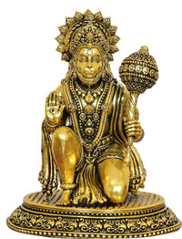 Golden Hanuman JI brass statue close-up, jeweled crown and raised hand mace