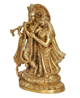 Brass Radha Krishna statue viewed from side, detailed garments and crowns