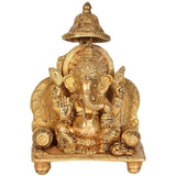 Brass Ganesha idol statue on sinhaasan, seated with ornate halo and canopy