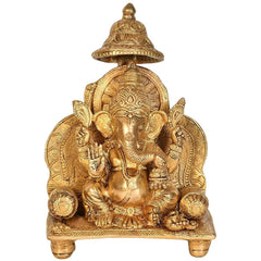 Brass Ganesha idol statue on sinhaasan, seated with ornate halo and canopy