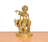 Brass Lord Krishna playing flute with cow idol on round base, golden tone