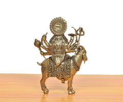 Back view of brass MATA idol seated on goat, engraved backplate and accessories